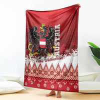Red Christmas eagle blanket draped over chair, with snowflake dots and diamond knit pattern