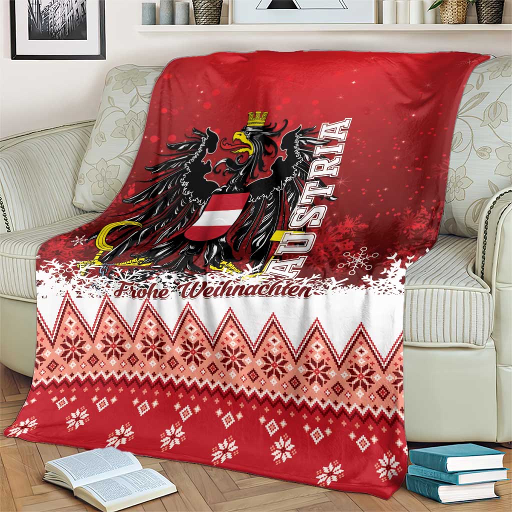 Red and white Christmas eagle blanket on couch, featuring crest, snowflakes, and diamond motifs