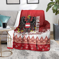 Red Christmas eagle blanket with white patterned hem, folded over sofa with holiday design