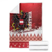 Red Christmas eagle blanket with two folded white pieces, snowflakes and diamond stripe pattern