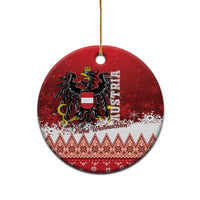 Red round Austria eagle ceramic Christmas ornament on gold string, with greeting text at bottom