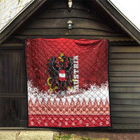 Red Christmas quilt displayed indoors, eagle crest center, white snowflake and fair isle stripes