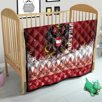 Red Christmas quilt on wooden baby bed, eagle crest center with white snowflake border
