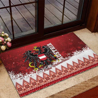 Red Christmas eagle rubber doormat with black emblem, snowy speckles, and patterned edge.