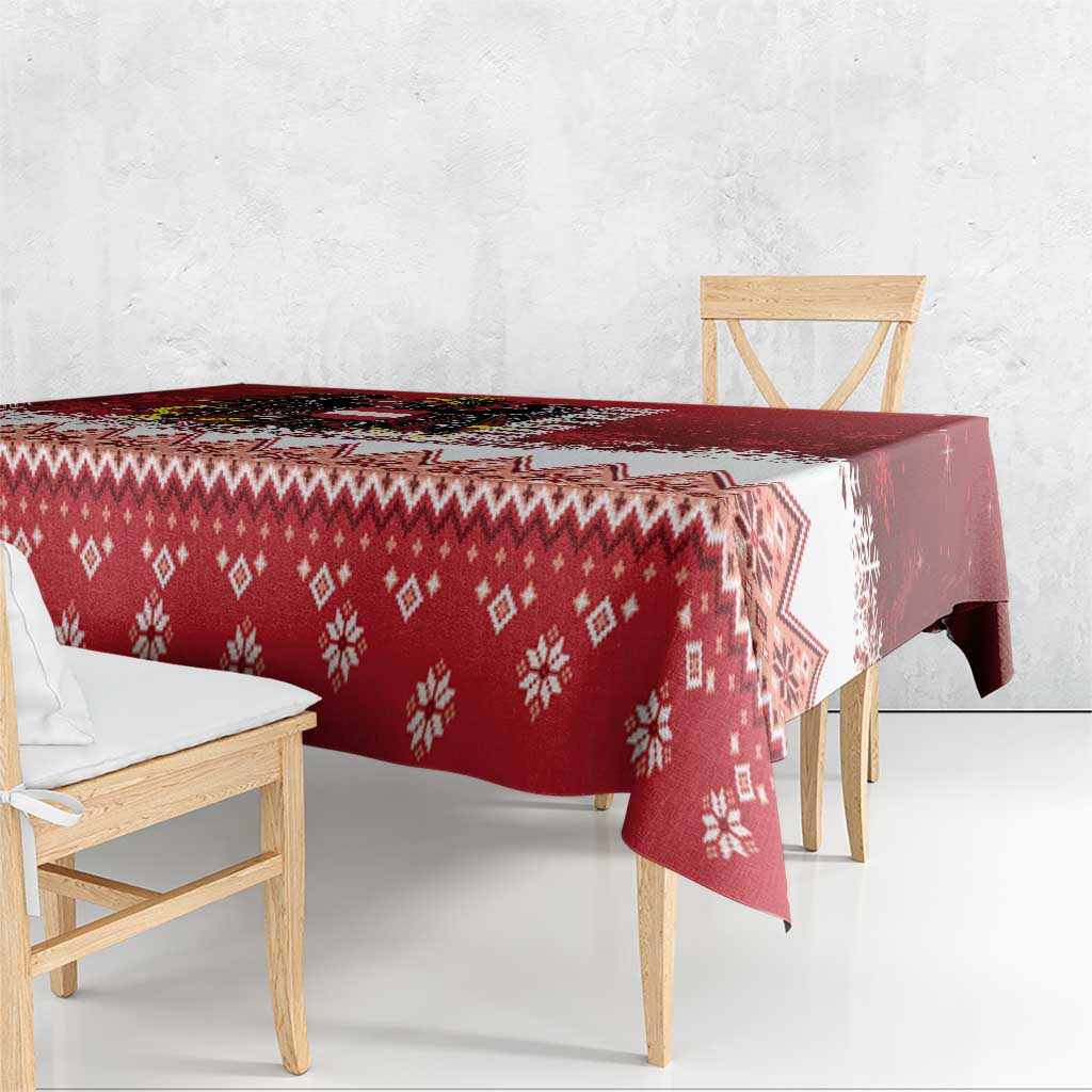 Red Christmas tablecloth corner with repeating snowflake and geometric diamond pattern