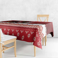 Red Christmas tablecloth corner with repeating snowflake and geometric diamond pattern