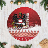 Red round Christmas tree skirt with black eagle, ornament and woven-pattern border, fringe-free.
