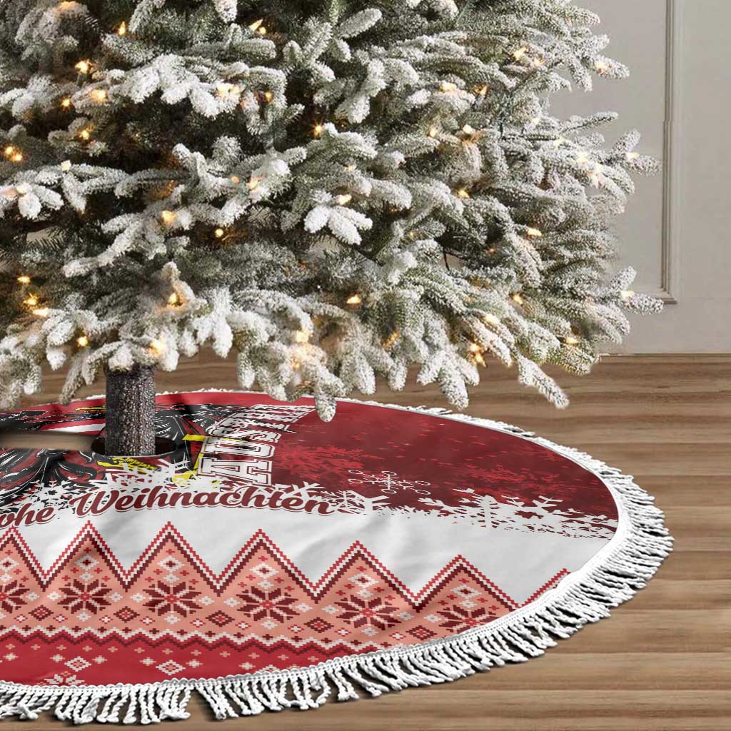 Red and white round Christmas tree skirt with black eagle design and tasseled edge.