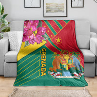 Grenada themed blanket draped with red, yellow, green diagonal stripes, crest and flowers