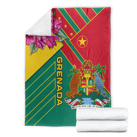 Folded Grenada themed blanket with red, yellow, green diagonal stripes, crest emblem, orchid flowers