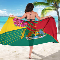 Grenada sarong held open in red and green with yellow trim and coat-of-arms graphics