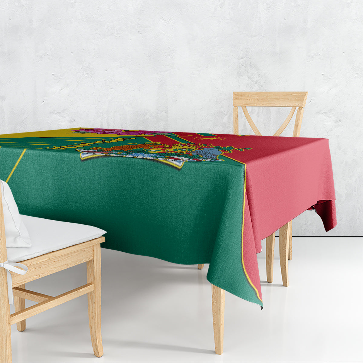 Green and red tablecloth with yellow trim and Grenada emblem draped over table edge