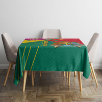 Green and red tablecloth with yellow and purple border, Grenada crest centered