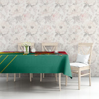 Green and red tablecloth with Grenada emblem and yellow border on dining table