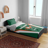 Green cricket bedding set on bed with SAUDI ARABIA logo and crossed bat emblem