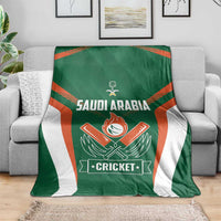 Green cricket blanket draped over sofa, showing Saudi Arabia text and Cricket logo