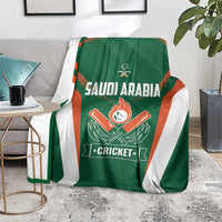 Green Saudi Arabia cricket blanket draped on sofa, with orange-striped emblem and Cricket text