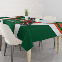 Green cricket tablecloth with logo and orange stripes, draped over dining table