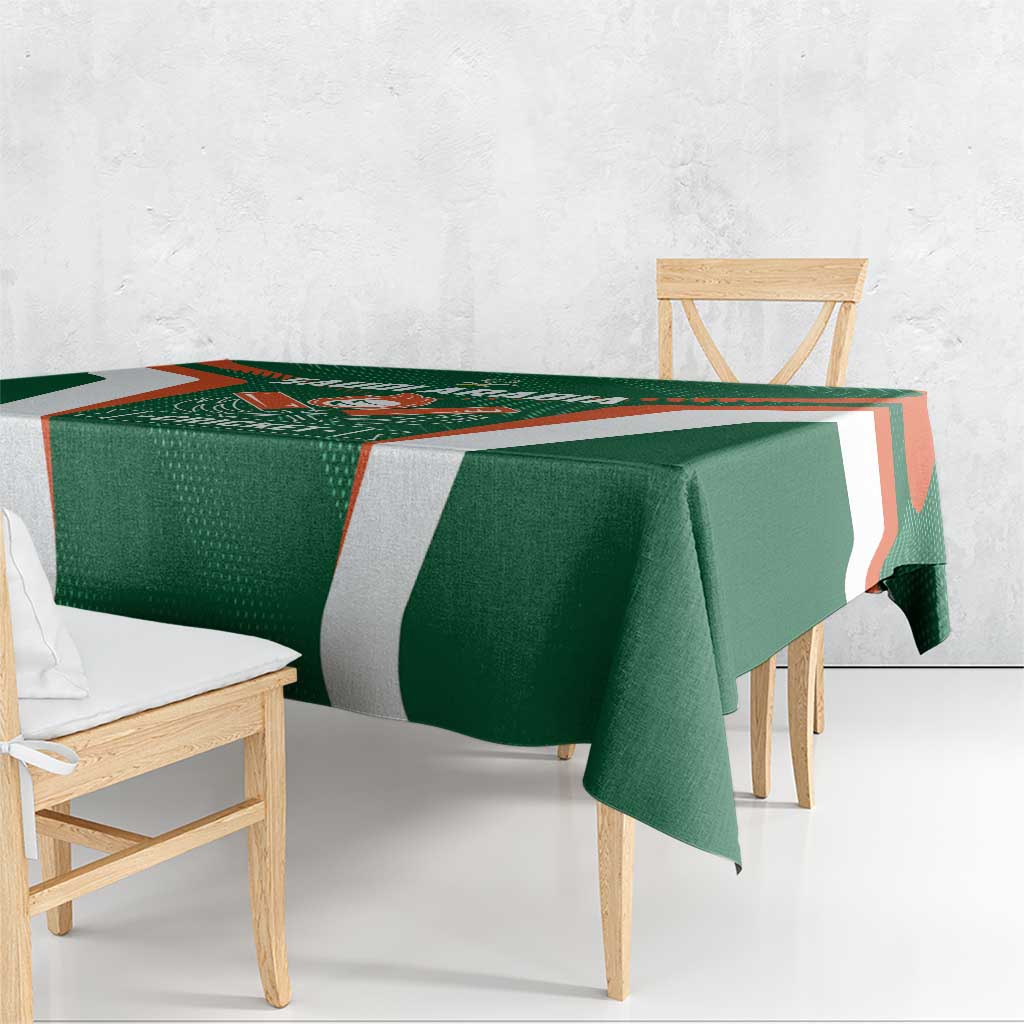 Green and white cricket tablecloth with orange border accents on wooden table