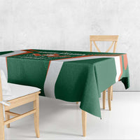 Green and white cricket tablecloth with orange border accents on wooden table