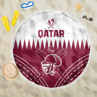 Round beach blanket with Qatar logo and maroon cricket helmet emblem, white fringed edge