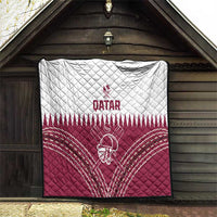 Qatar cricket quilt hanging on outdoor wall, white top and red bottom with helmet graphic