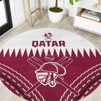 Red round cricket carpet with white Qatar branding and bat-and-helmet team emblem