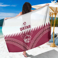 Qatar cricket sarong stretched wide; maroon bottom with large white Qatar crest