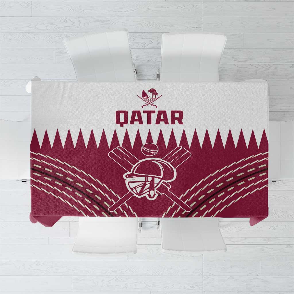 Folded red tablecloth featuring Qatar cricket emblem and white geometric rays