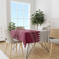 Red tablecloth with white Qatar cricket emblem and bold zigzag line pattern