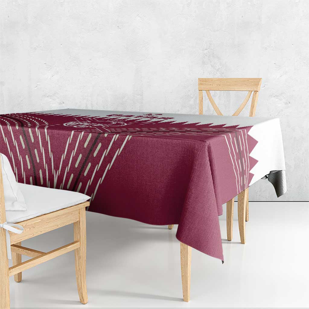 Maroon red tablecloth with white Qatar cricket emblem and geometric streaks