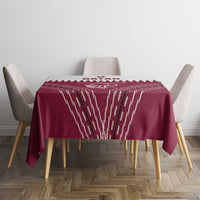 Red tablecloth with white Qatar cricket graphic and geometric streak pattern