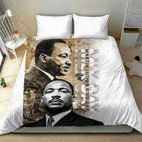 White bedding set with MLK portrait print duvet and two pillowcases, full-bed view