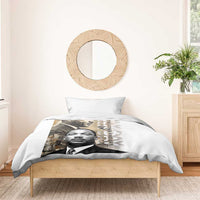 White bedding set with MLK portrait print duvet and two pillowcases on wooden bed