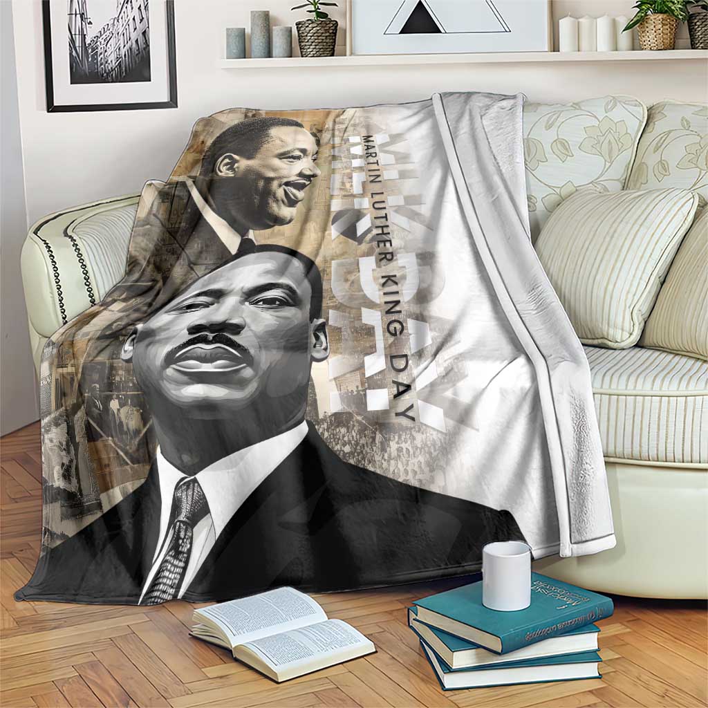 White blanket with black-and-gray portrait print of Martin Luther King Jr and vertical day text