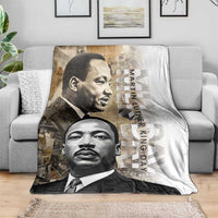 White blanket draped over a couch with two grayscale portraits and vertical “Martin Luther King Day”