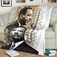 White blanket on sofa with two grayscale portraits and “Martin Luther King Day” lettering