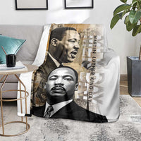 White blanket on seating with grayscale portraits and vertical “Martin Luther King Day” text