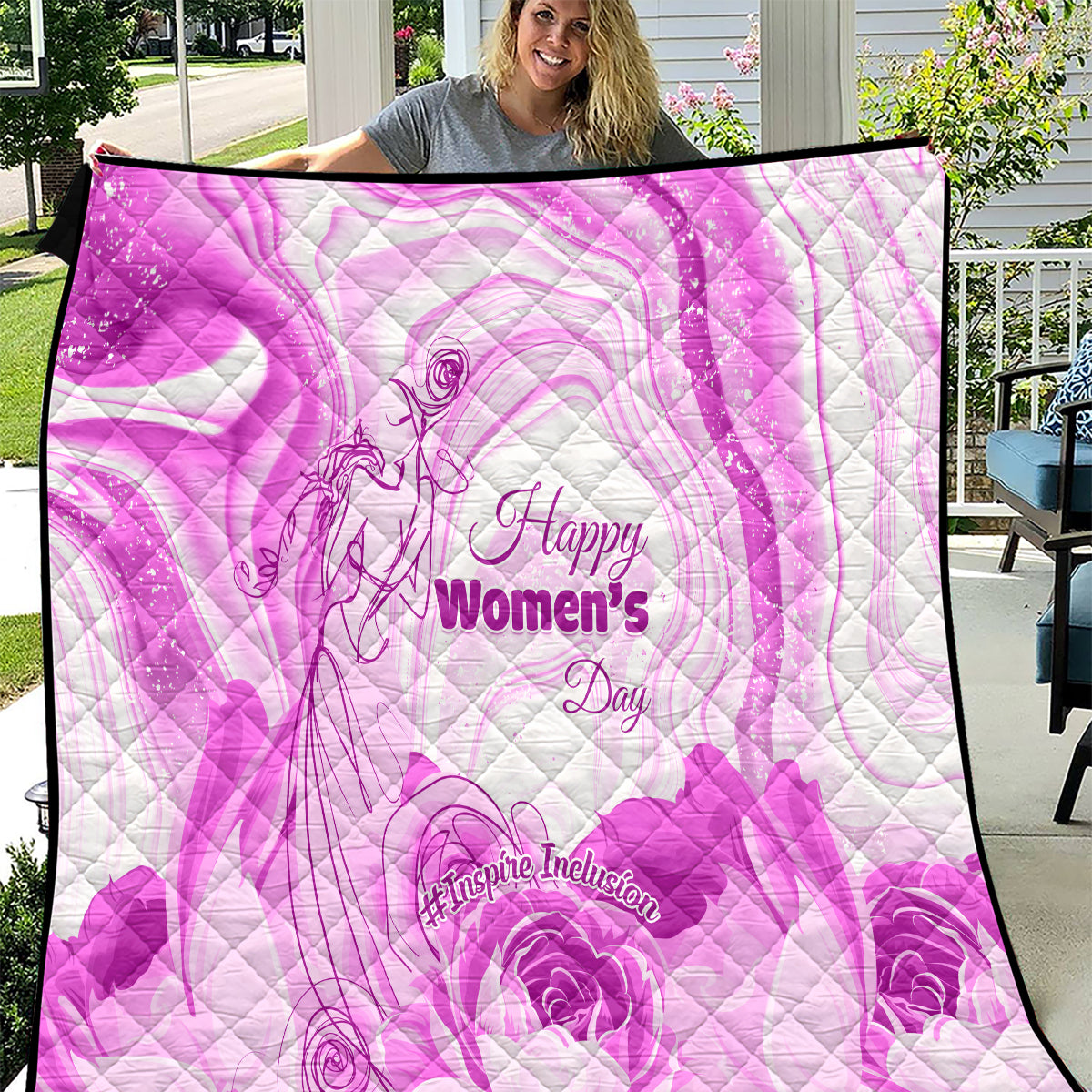 Purple quilt with quilted swirl floral design and 'Happy Women's Day' text
