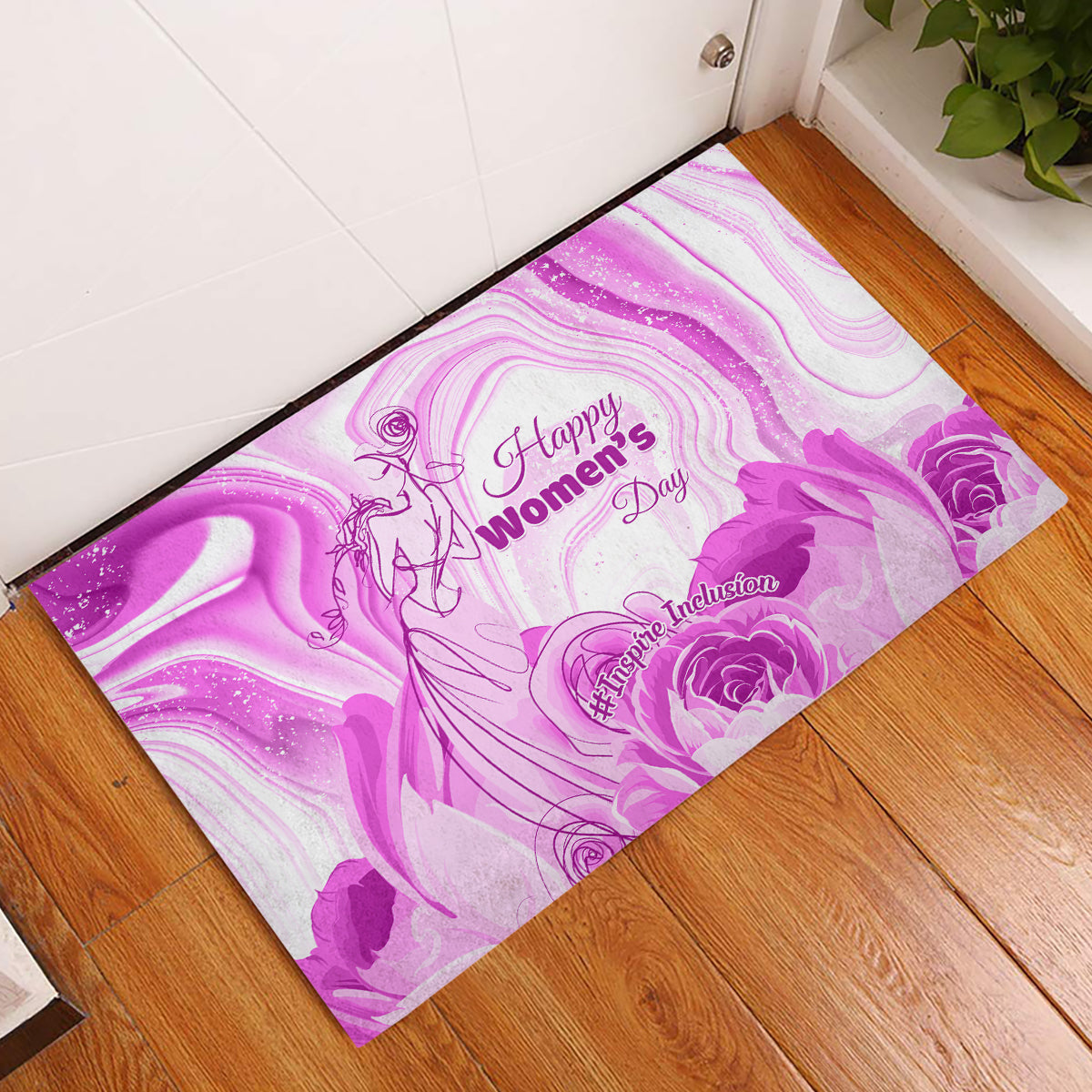 Purple rubber doormat on hardwood floor with “Happy Women’s Day” and floral motifs