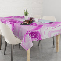 Purple printed tablecloth with floral swirls, laid across a table surface