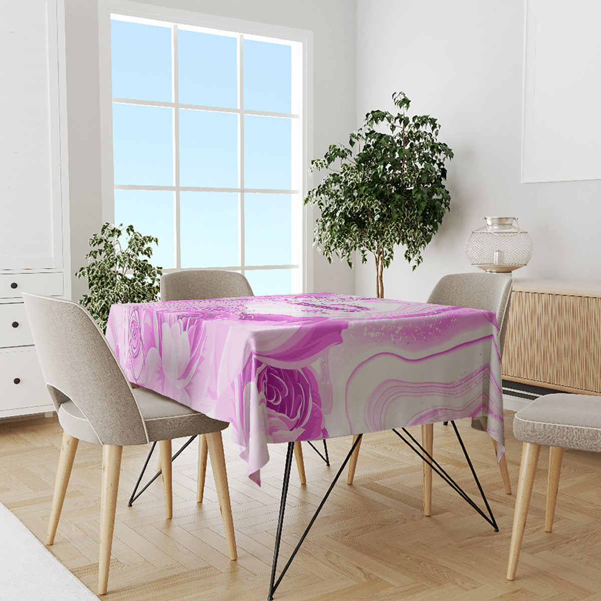 Purple floral swirls tablecloth draped over a dining table with chairs