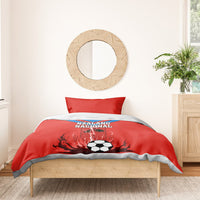 Red football duvet with soccer ball and flame graphic, Nzalang Nacional on the front