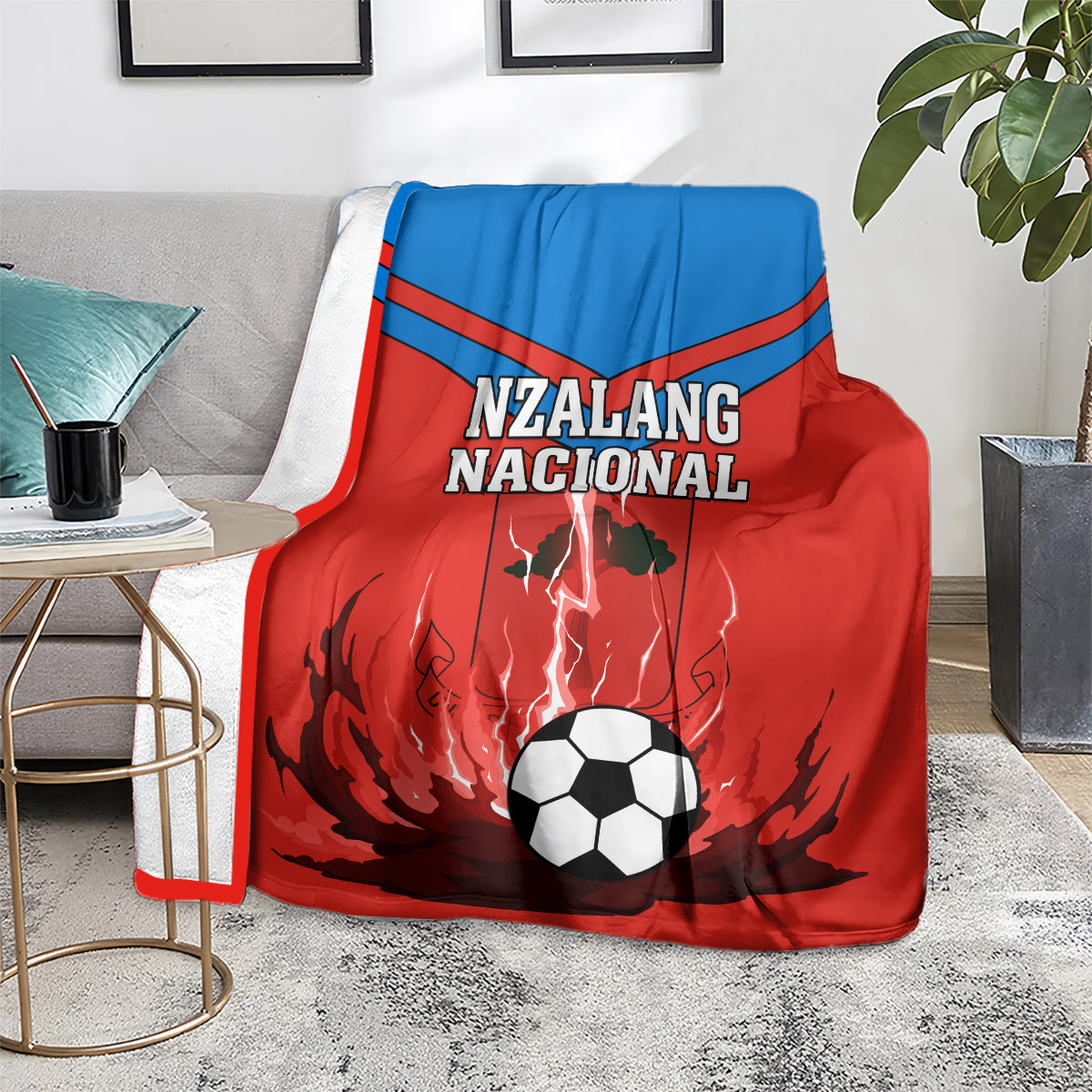 Equatorial Guinea football blanket on couch, red/blue Nzalang Nacional with soccer-ball graphic