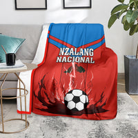 Equatorial Guinea football blanket on couch, red/blue Nzalang Nacional with soccer-ball graphic