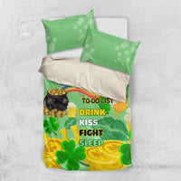 Green and yellow shamrock-themed duvet with pillowcases showing “Drink Kiss Fight Sleep”