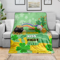 Green St. Patrick's Day blanket on gray sofa with clovers, rainbow, and playful text