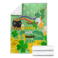 Green St. Patrick's Day blanket with clovers and rainbow, folded with white towels