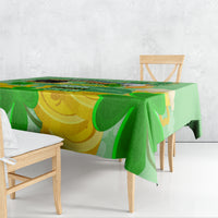 Green and gold shamrock tablecloth with clover motif, draped over dining table