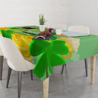 Green and gold shamrock tablecloth over table edge, clover pattern with curved shapes